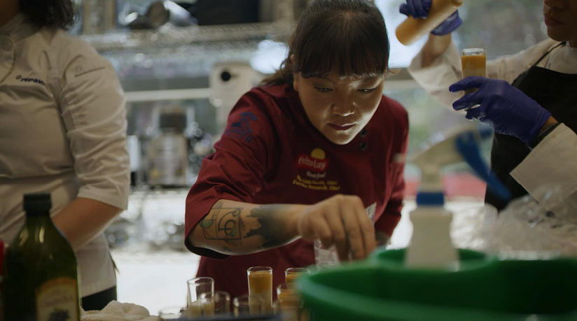 Frito-Lay chef Ngoc Trinh carefully supervises the latest meal she just created.(Courtesy Frito-Lay)